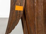 a close up of a piece of wood with an orange tag on it