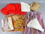 a pile of clothes and a bag on a table