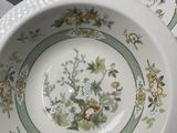 three plates with floral designs on them on a table