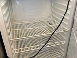 a white refrigerator with a door open in a kitchen