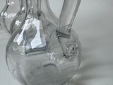 three clear glass vases sitting next to each other