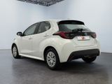the back of a white toyota ay parked in a room
