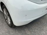a white car that is parked in a parking lot