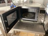 a microwave that is sitting on a table in the kitchen
