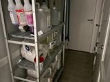 a shelf that has several bottles of cleaning products on it