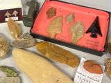 many different types of artifacts displayed on a table