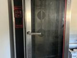 a commercial oven with a glass door in a commercial kitchen