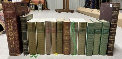 Plusieurs vieux livres sont empilés sur une table dans une pièce