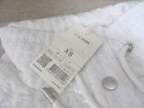 a white towel with a toothbrush and a tag on it
