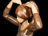 statue of a woman holding her hair in her hands