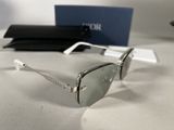 silver sunglasses on a white table with a blue box in the background