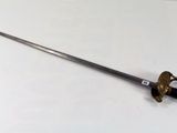 a sword that is laying on a white surface