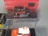 three toy cars in a display case on a table