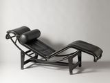 a black leather chaise lounger with a black leather cushion