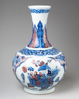 a blue and white vase sitting on a table