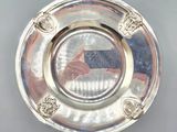 a silver plate with a picture of a person on it