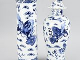 two blue and white vases with dragon designs on them