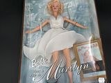 the barbie doll is in a box with a picture of marilyn on it