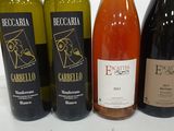 several bottles of wine are lined up on a table