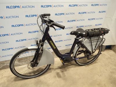 a bike that is parked in front of a wall
