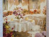 an oil painting of a table with flowers and chairs in front of a white wall