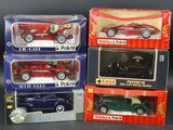 three boxed boxed toy cars in boxes on a black surface