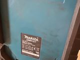 a close up of a blue tool box with a black handle