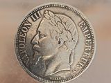 a silver coin with a picture of a woman on it