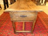a wooden table with a drawer on top of it