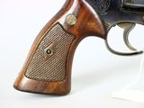 the gun is made of wood and has a metal handle