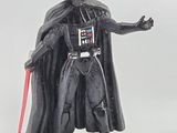 star wars figurine of dart vader holding a red light saber