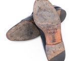 a pair of shoes that are sitting on a white surface