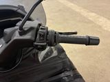 a close up of a motorcycle handlebar with a bag on the back