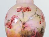 a vase that has a painting of flowers on it