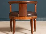 a chair that has a leather seat on it