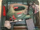 a green box with tools in it on a table