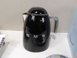 a black coffee pot sitting on a counter next to a blender