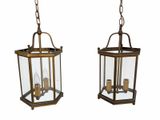 pair of antique brass hanging lanterns with glass panels