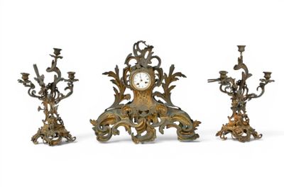 three antique clocks sitting next to each other on a white surface