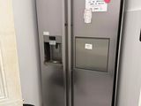 a silver refrigerator in the corner of a kitchen