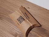 a brown paper bag sitting on top of a wooden table