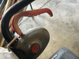 a small child ' s bike with a handlebar attached to it