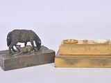 a small statue of a dog and a cat next to a box