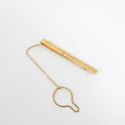 a gold plated necklace with a long chain attached to it