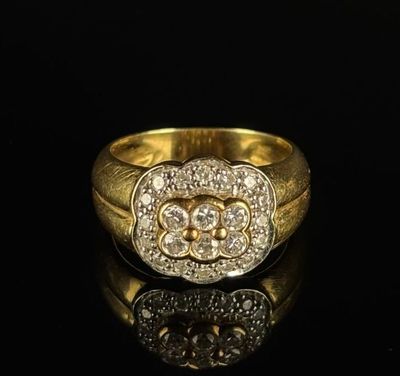 a close up of a gold and diamond ring on a black surface