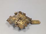an image of a gold brooch with a cross on top of it