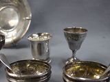 a silver plate with spoons and cups on a table