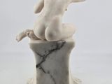 an image of a statue of a woman sitting on top of a marble block