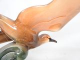 a bird that is sitting on top of a glass object