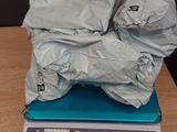 a pile of bags on top of a scale on a table